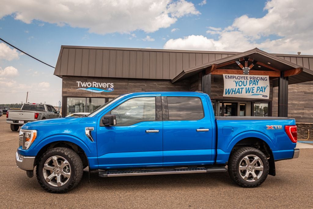 2021 Ford F-150 XLT in Velocity Blue Metallic — front three-quarter view