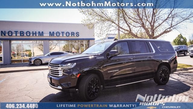 2024 Chevrolet Suburban High Country in Black — front three-quarter view
