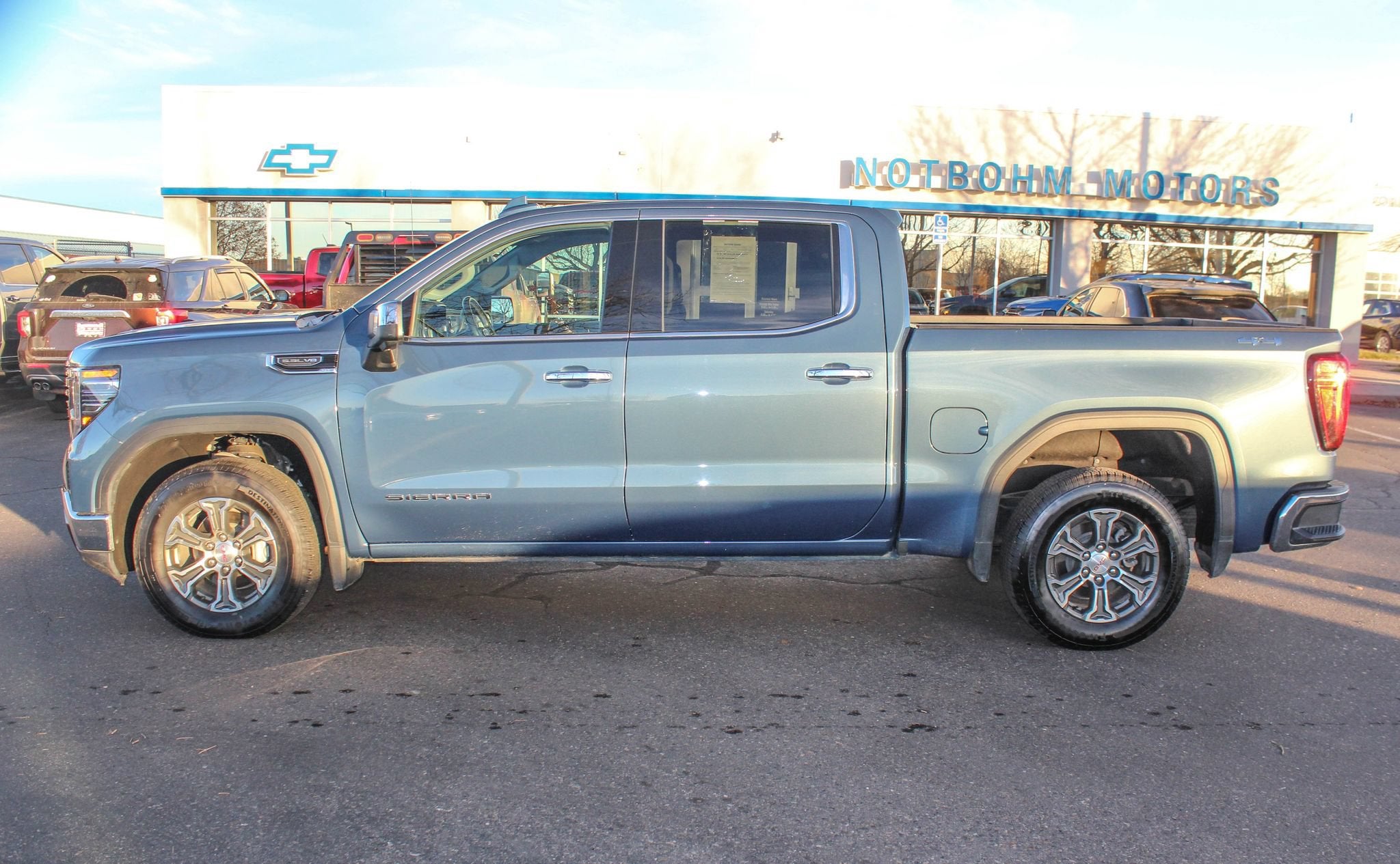 2024 GMC Sierra 1500 SLT in Downpour Metallic — front three-quarter view