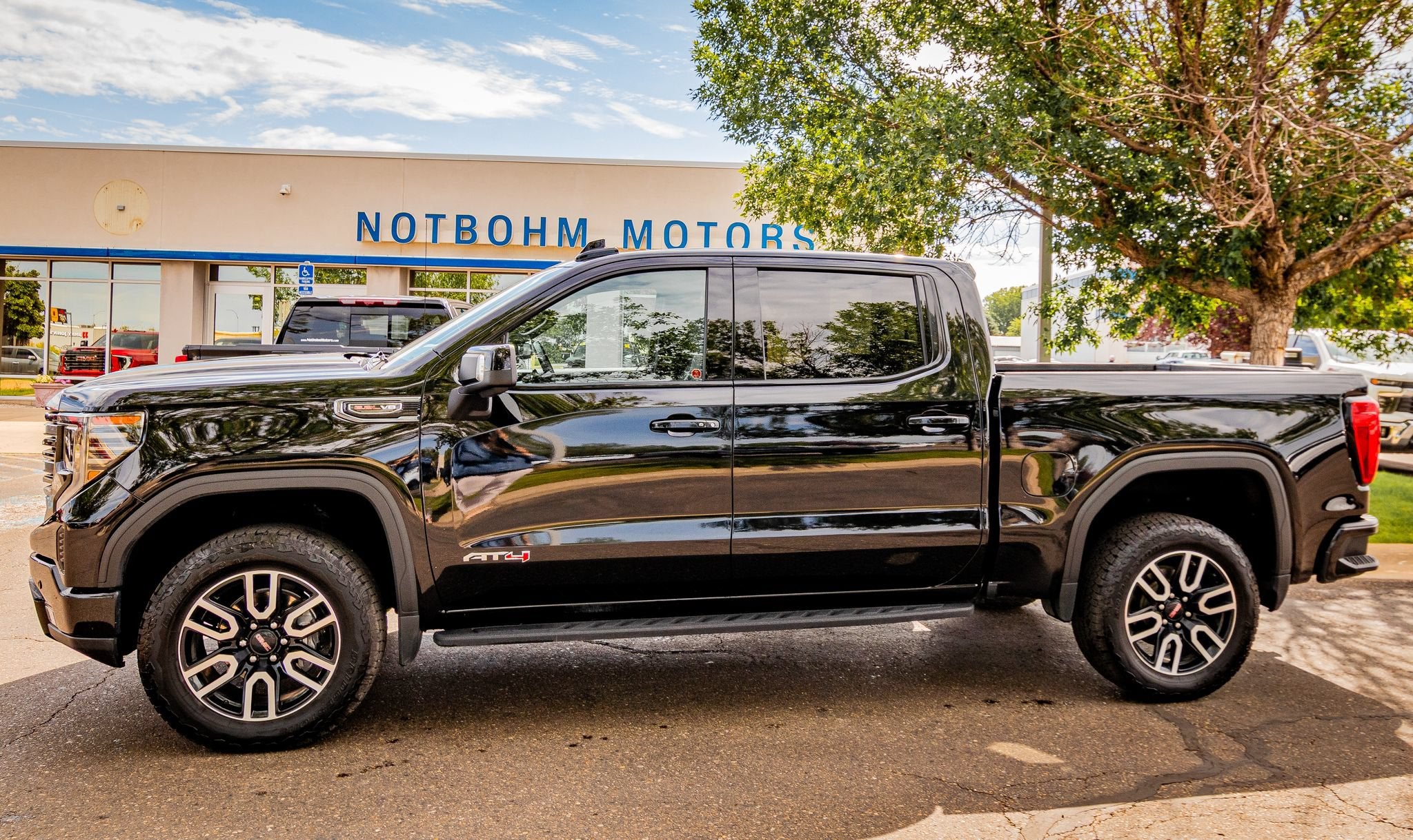 2023 GMC Sierra 1500 AT4 in Onyx Black — front three-quarter view