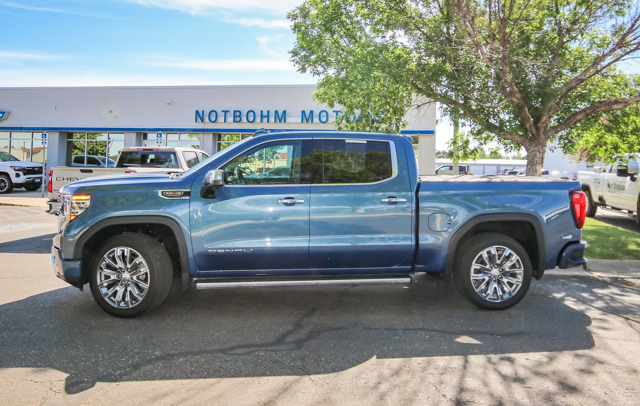 2025 GMC Sierra 1500 Denali in Downpour Metallic — front three-quarter view